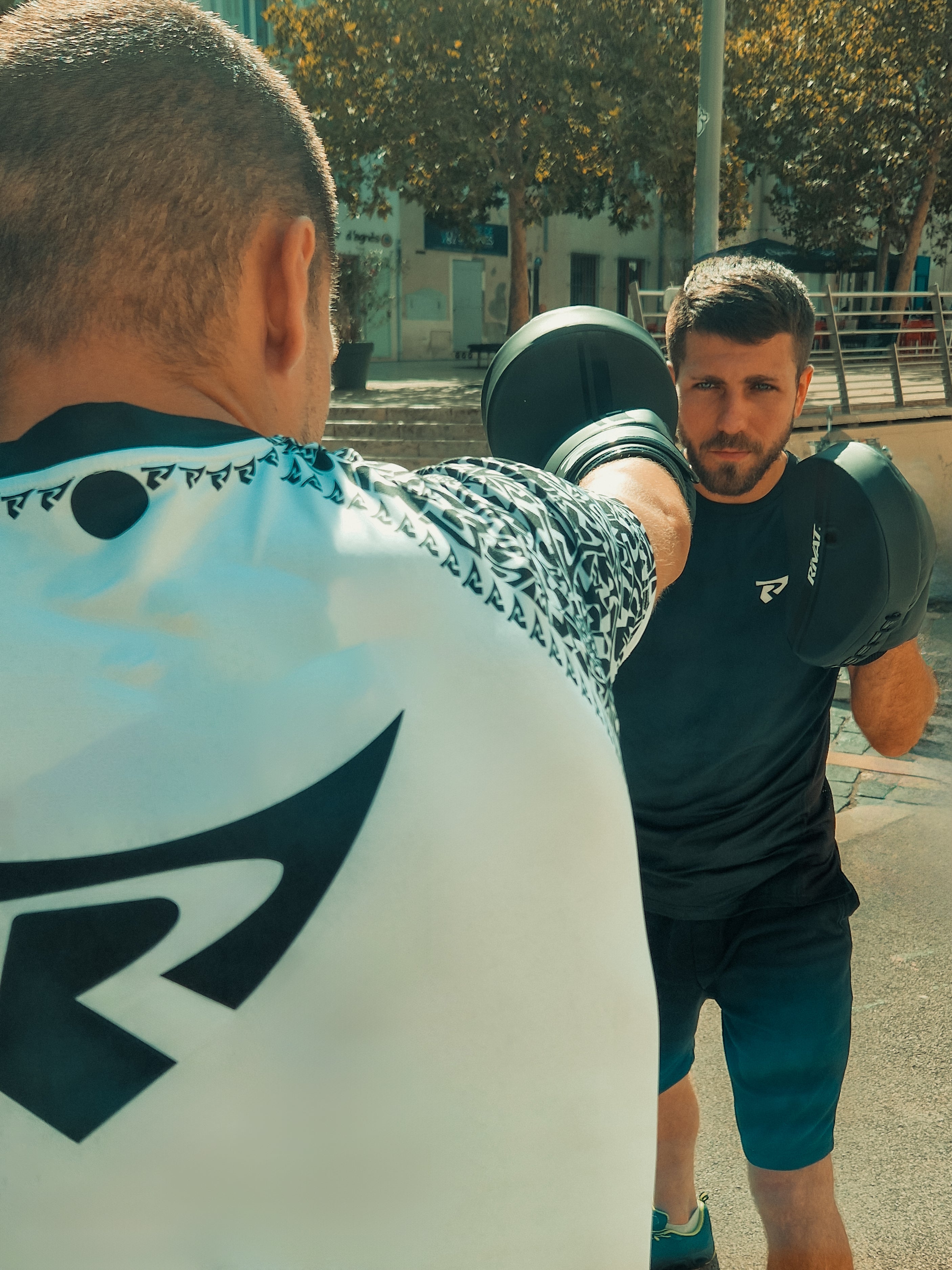 Entraînement de boxe avec des sportifs portant du textile technique boxe française pour performance et confort